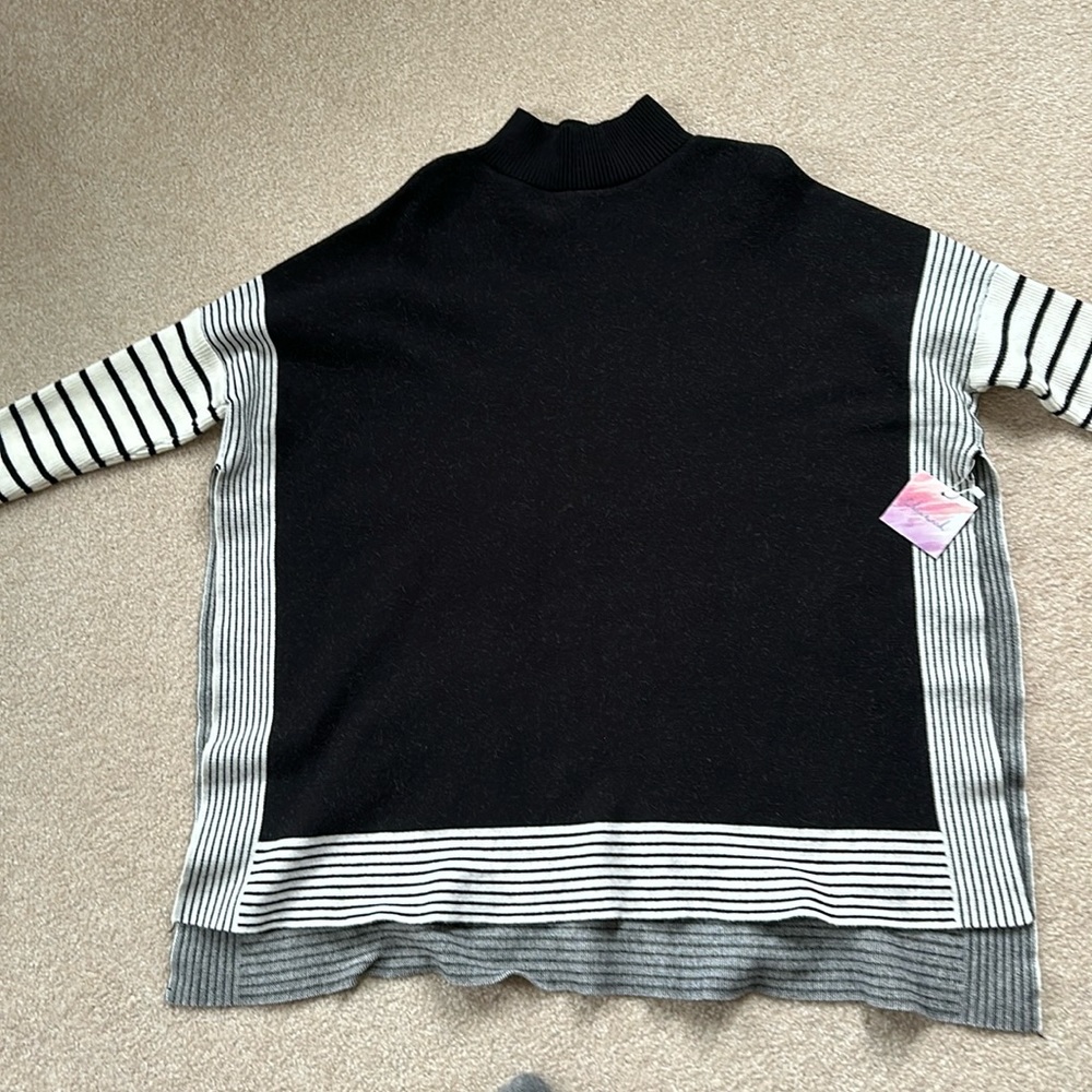 Black and white mock turtle neck sweater. High slits on side. .